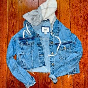A Forever 21 cropped Jean jacket with a hood. It is a size small.